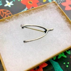 Antique wishbone pin with lifelike detailing